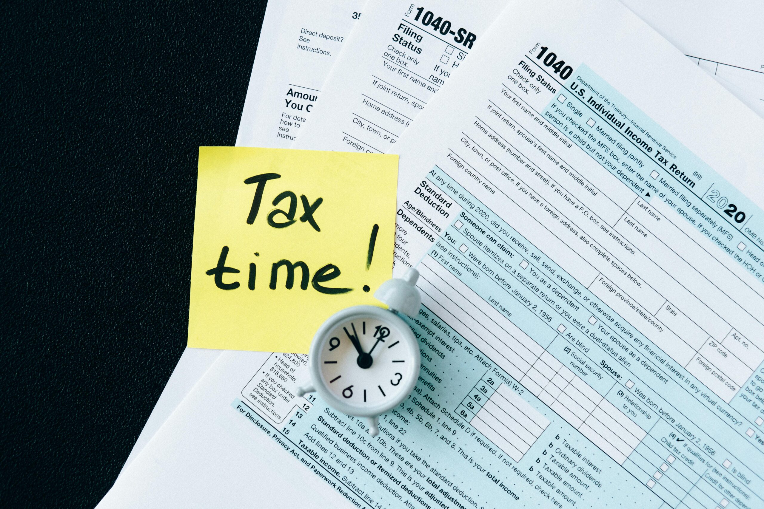 "People checking ITR deadline update on a phone screen with tax documents in the background"